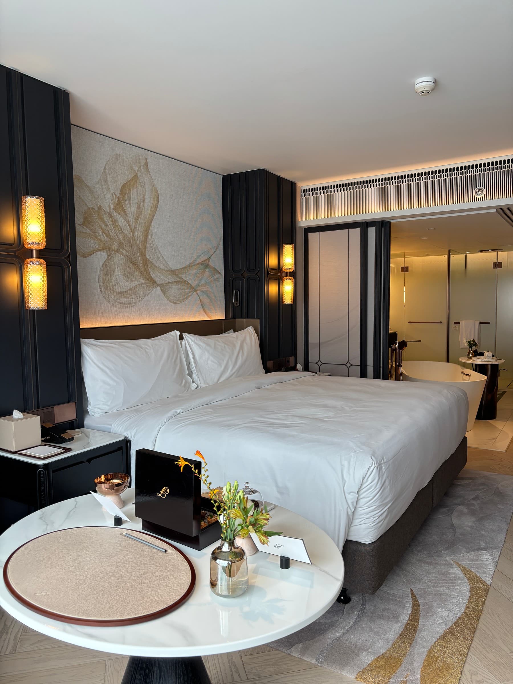 The Deluxe King photographed during Redgie’s visit, with the bathroom visible beyond the bed.